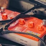 Removing an old car battery to install a new battery