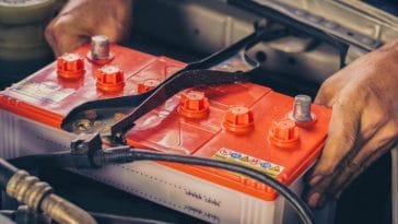 Removing an old car battery to install a new battery