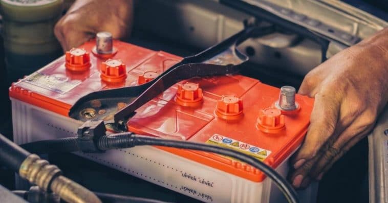 Removing an old car battery to install a new battery