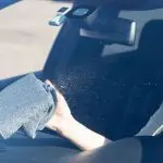Wiping inside of my windshield with the glass cleaner