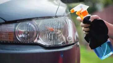 Cleaning cloudy headlight outside of my garage using a kit