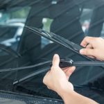 Installing new windshield wipers using the replacement guide on the web