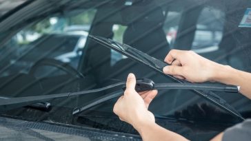 Installing new windshield wipers using the replacement guide on the web