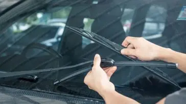 Installing new windshield wipers using the replacement guide on the web