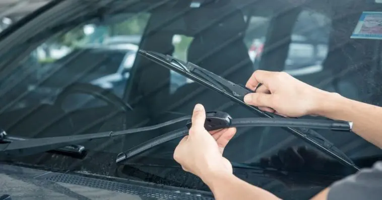 Installing new windshield wipers using the replacement guide on the web