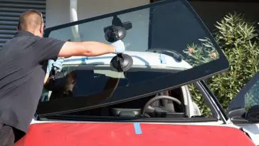 Changing a craked windshield outside of my garage and pay the repair price