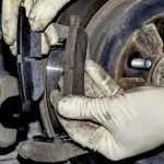 Changing new brake pads at an automotive shop