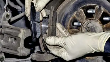 Changing new brake pads at an automotive shop