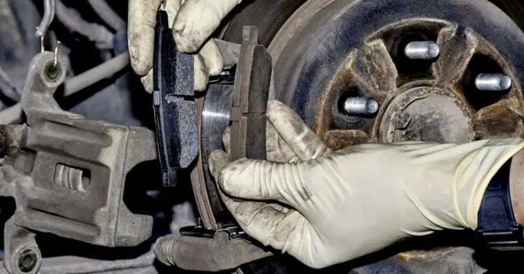 Changing new brake pads at an automotive shop