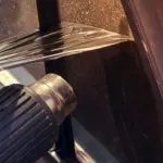 Taking off my old window tint with a heat gun in my garage