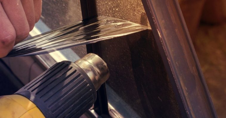 Taking off my old window tint with a heat gun in my garage